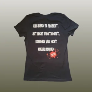 girlie-radikaleakzeptanz-back Die Rückseite des schwarzen Girlieshirts Radikale Akzeptanz mit weißem Text und rotem Fleck.